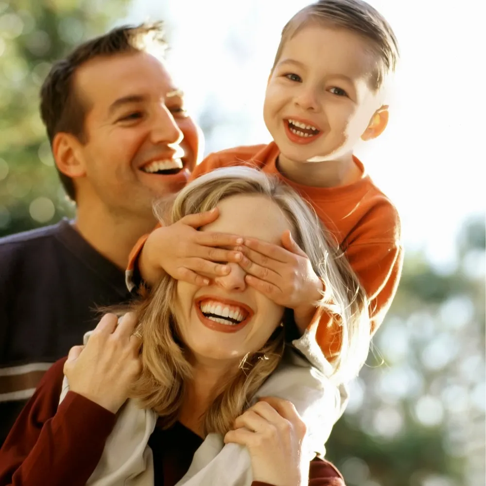 Smiling family enjoying time together representing families receiving dental care through the Canadian Dental Care Plan at Riverfront Dental in Cambridge Ontario